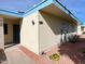 Tan house exterior with blue accents and landscaping at 10976 W Coggins Dr, Sun City, AZ 85351