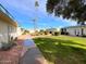 Community view showing building exteriors, landscaping, and walkways at 10976 W Coggins Dr, Sun City, AZ 85351