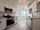 Modern kitchen with white cabinets and granite counters at 10976 W Coggins Dr, Sun City, AZ 85351