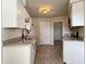 White kitchen cabinets, granite countertops, and tile floors at 10976 W Coggins Dr, Sun City, AZ 85351