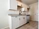White kitchen with granite countertops and stainless steel appliances at 10976 W Coggins Dr, Sun City, AZ 85351
