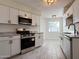 Modern kitchen with white cabinets and granite counters at 10976 W Coggins Dr, Sun City, AZ 85351
