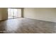 Bright living room with tile floors and sliding glass door to patio at 10976 W Coggins Dr, Sun City, AZ 85351