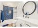 Bathroom boasts blue tile shower and white vanity at 12058 N Loma Linda St, Surprise, AZ 85388