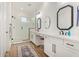 Modern bathroom with white vanity, frameless shower, and stylish mirrors at 12058 N Loma Linda St, Surprise, AZ 85388