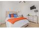 Secondary bedroom with a comfortable bed and built-in desk at 12058 N Loma Linda St, Surprise, AZ 85388