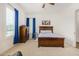 Bright bedroom with wood bed frame and blue curtains at 12058 N Loma Linda St, Surprise, AZ 85388