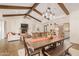 Elegant dining area with a large wooden table and exposed beams at 12058 N Loma Linda St, Surprise, AZ 85388