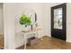 Bright entryway with a white console table, round mirror, and wood floors at 12058 N Loma Linda St, Surprise, AZ 85388