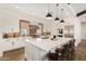 Gourmet kitchen featuring a large island with seating, stainless steel appliances, and brick backsplash at 12058 N Loma Linda St, Surprise, AZ 85388