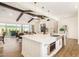 Open concept kitchen with large island, stainless steel appliances, and hardwood floors at 12058 N Loma Linda St, Surprise, AZ 85388