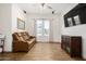 Comfortable living area with leather couch and wood flooring at 12058 N Loma Linda St, Surprise, AZ 85388