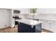 Modern kitchen with white cabinets, island, and stainless steel appliances at 1243 N Terripin --, Mesa, AZ 85207