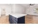 Modern kitchen with white cabinets and a navy blue kitchen island at 1243 N Terripin --, Mesa, AZ 85207