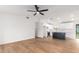 Open living room with kitchen access, wood floors, and ceiling fan at 1243 N Terripin --, Mesa, AZ 85207