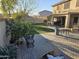 Large backyard with patio, grass, and fruit trees at 12701 W Paradise Dr, El Mirage, AZ 85335