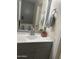 Bathroom with vanity, mirror, and grey cabinetry at 12701 W Paradise Dr, El Mirage, AZ 85335