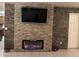 Modern electric fireplace with stone surround at 12701 W Paradise Dr, El Mirage, AZ 85335