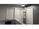 Upstairs hallway with three doors and framed art at 12701 W Paradise Dr, El Mirage, AZ 85335