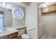 Bathroom with stained glass window, vanity, toilet and access to laundry area at 12851 N Mimosa Dr # 102, Fountain Hills, AZ 85268