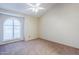 Bedroom with vaulted ceiling, carpet, and arched window with shutters at 12851 N Mimosa Dr # 102, Fountain Hills, AZ 85268