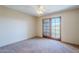 Bright bedroom with carpeted floor and sliding glass doors to balcony at 12851 N Mimosa Dr # 102, Fountain Hills, AZ 85268