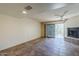 Living room with tile floors, fireplace, and sliding glass doors leading to a patio at 12851 N Mimosa Dr # 102, Fountain Hills, AZ 85268