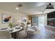 Virtually staged living room with dining area and fireplace at 12851 N Mimosa Dr # 102, Fountain Hills, AZ 85268