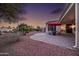 Private backyard with a covered patio, desert landscaping and sunset views at 12953 W Figueroa Dr, Sun City West, AZ 85375