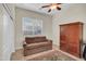 Comfortable bedroom with a sofa bed, closet, and large window providing natural light at 12953 W Figueroa Dr, Sun City West, AZ 85375