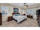 Comfortable bedroom with a ceiling fan, white bedspread and coordinated furnishings at 12953 W Figueroa Dr, Sun City West, AZ 85375