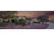 Desert landscaping surrounds this house with trees, plants, and red rock at 12953 W Figueroa Dr, Sun City West, AZ 85375