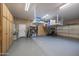 Clean and organized garage featuring epoxy flooring, custom cabinets, and ample storage at 12953 W Figueroa Dr, Sun City West, AZ 85375