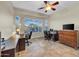 Bright home office with multiple workstations, large windows, and ample desk space at 12953 W Figueroa Dr, Sun City West, AZ 85375