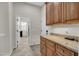 Convenient laundry room with cabinets, granite countertops, and easy access to appliances at 12953 W Figueroa Dr, Sun City West, AZ 85375