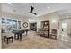 Spacious living area featuring tile flooring, natural light, piano, and comfortable seating at 12953 W Figueroa Dr, Sun City West, AZ 85375