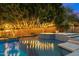 Relaxing pool and spa with string lights at night at 13176 E Summit Dr, Scottsdale, AZ 85259