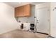 Laundry room with upper cabinets and a utility sink at 1360 E Century Ave, Gilbert, AZ 85296