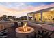 Sunset view of backyard oasis with firepit and seating at 14821 E Chandler Heights Rd, Chandler, AZ 85249