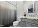 Well-lit bathroom with shower, toilet and gray vanity at 14821 E Chandler Heights Rd, Chandler, AZ 85249