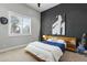 Modern bedroom featuring a bed, nightstand, and large wall art at 14821 E Chandler Heights Rd, Chandler, AZ 85249
