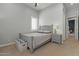 Bright bedroom with a comfortable bed, nightstand, and window with shutters at 14821 E Chandler Heights Rd, Chandler, AZ 85249