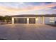 Two-car garage with modern doors and exterior lighting at 14821 E Chandler Heights Rd, Chandler, AZ 85249