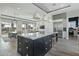 Modern kitchen with a large island, stainless steel appliances, and white cabinetry at 14821 E Chandler Heights Rd, Chandler, AZ 85249