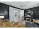 Spacious home office with built-in shelving and a comfortable seating area at 14821 E Chandler Heights Rd, Chandler, AZ 85249