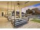 Relaxing covered patio with a swing and scenic backyard views at 14821 E Chandler Heights Rd, Chandler, AZ 85249