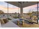 Covered patio with comfortable seating and views of pool and landscape at 14821 E Chandler Heights Rd, Chandler, AZ 85249