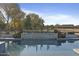 Modern pool with stone accents and views of the surrounding landscape at 14821 E Chandler Heights Rd, Chandler, AZ 85249