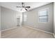 Bright bedroom with ceiling fan and wood-look floors at 14866 W Windsor Ave, Goodyear, AZ 85395