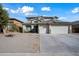 Two-story house with a three-car garage and desert landscaping at 14866 W Windsor Ave, Goodyear, AZ 85395